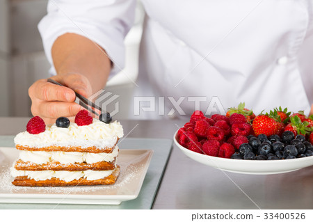 Pastry chef decorating Pastry chef decorating 33400526