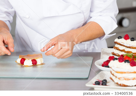 Pastry chef decorating Pastry chef decorating 33400536