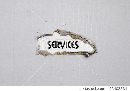 The word services appearing behind torn paper 33402284