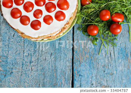 zucchini cake with tomato and parsley on a blue zucchini cake with tomato and parsley on a blue 33404787