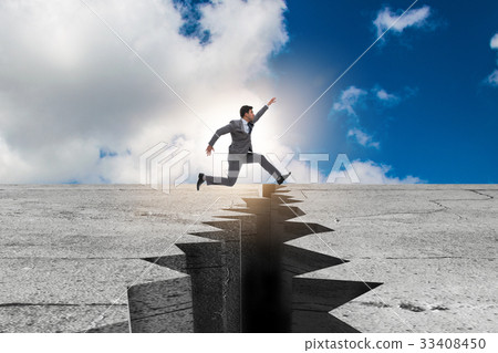 Businessman jumping over the cliff 33408450