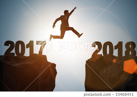 Businessman looking forward to 2018 from 2017 Businessman looking forward to 2018 from 2017 33408451