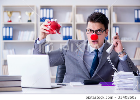 Clown businessman with piggy bank doing accounting Clown businessman with piggy bank doing accounting 33408602