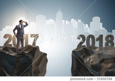 Businessman looking forward to 2018 from 2017 Businessman looking forward to 2018 from 2017 33408766
