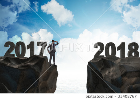 Businessman looking forward to 2018 from 2017 Businessman looking forward to 2018 from 2017 33408767