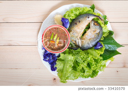 Fried two mackerels with vegetable on white 33410370