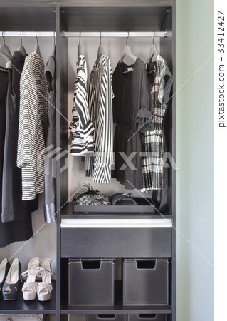 modern closet with row of black dress and shoes 33412427