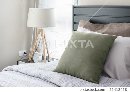 modern bedroom with green pillow and wooden lamp modern bedroom with green pillow and wooden lamp 33412458