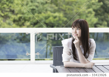 Smiling girl on the balcony of the villa 33413926