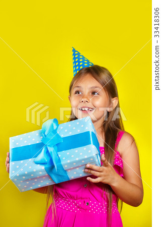 little girl wearing a party hat on her birthday little girl wearing a party hat on her birthday 33418306