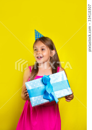 little girl wearing a party hat on her birthday 33418307