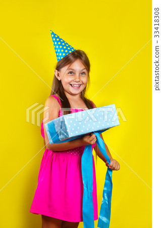 little girl wearing a party hat on her birthday little girl wearing a party hat on her birthday 33418308
