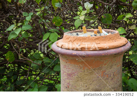 Smoked cigarettes in a dirty ashtray Smoked cigarettes in a dirty ashtray 33419052