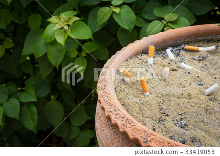 Smoked cigarettes in a dirty ashtray Smoked cigarettes in a dirty ashtray 33419053