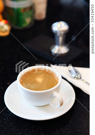 Creammy coffe in white cup with dark background 33419450