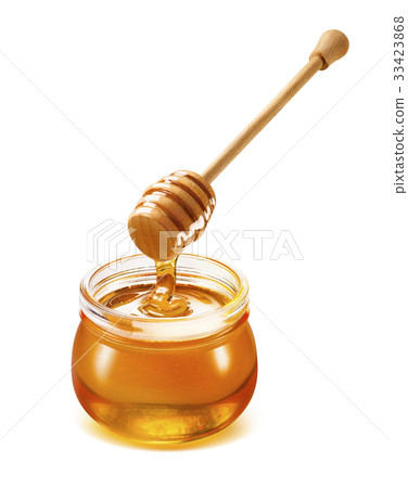 Honey dripping isolated from dipper into jar 33423868