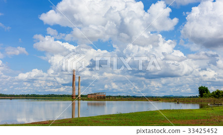 Old mill in the reservoir against blue sky Old mill in the reservoir against blue sky 33425452