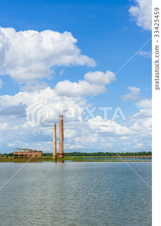 Old mill in the reservoir against blue sky Old mill in the reservoir against blue sky 33425459