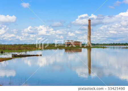 Old mill in the reservoir against blue sky Old mill in the reservoir against blue sky 33425490