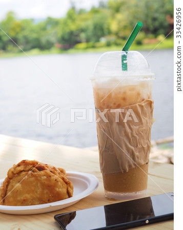 ice coffee with curry on wooden table. ice coffee with curry on wooden table. 33426956