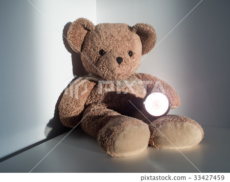 bear holding flashlight sitting alone emptiness bear holding flashlight sitting alone emptiness 33427459