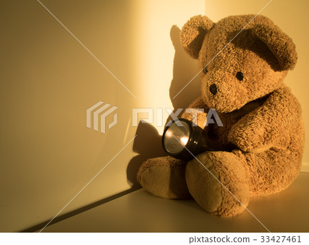 bear holding flashlight sitting alone emptiness bear holding flashlight sitting alone emptiness 33427461