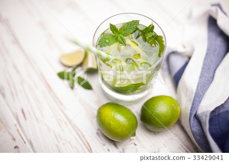 Mojito cocktail on white wood background Mojito cocktail on white wood background 33429041
