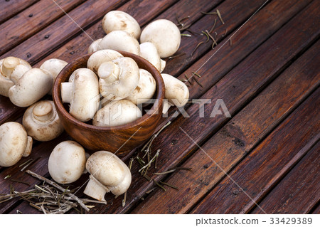 Mushrooms heap on wood background. Top view. Mushrooms heap on wood background. Top view. 33429389
