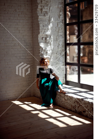 Young girl with closed eyes standing near the 33429709