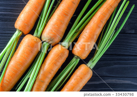 Fresh carrots on a wooden background, top view Fresh carrots on a wooden background, top view 33430798