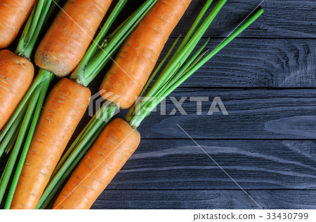 Fresh carrots on a wooden background, top view Fresh carrots on a wooden background, top view 33430799