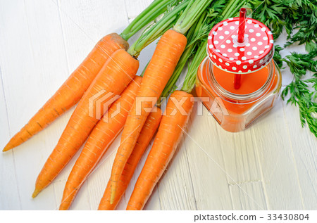 Carrot smoothie in a jar with carrots top view 33430804
