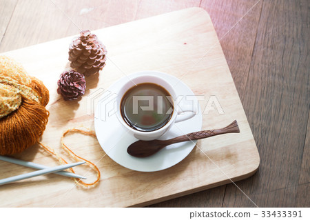 A cup of hot coffee with a yarn knitting A cup of hot coffee with a yarn knitting 33433391