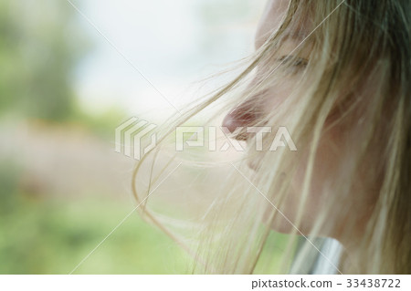 young girl traveling in car portrait with wind 33438722