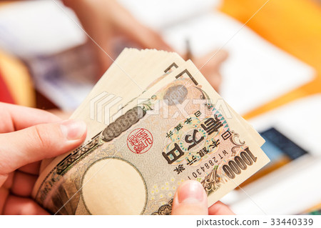 A person who counts money 33440339