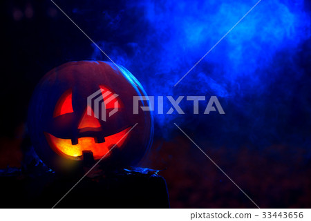 Smiling pumpkin for Halloween in dark at forest.  33443656
