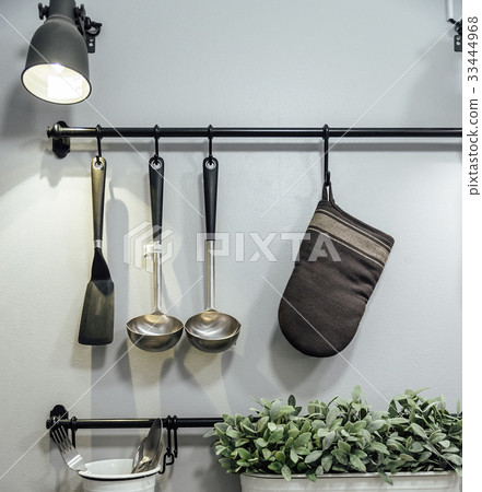 Kitchenware and tree hanging on the wall. Kitchenware and tree hanging on the wall. 33444968