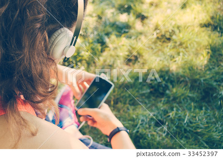 Cropped image of a girl in headphones Cropped image of a girl in headphones 33452397