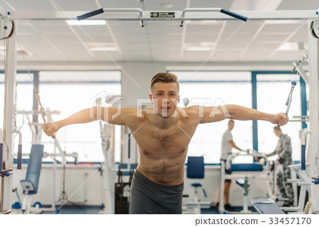 attractive man training on Fitness-station. Man attractive man training on Fitness-station. Man 33457170