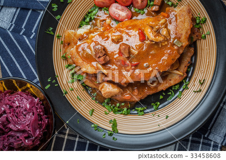 Potato pancakes with meat stew served on a plate. Potato pancakes with meat stew served on a plate. 33458608