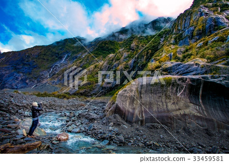 man take a photograph in franz josef glacier 33459581
