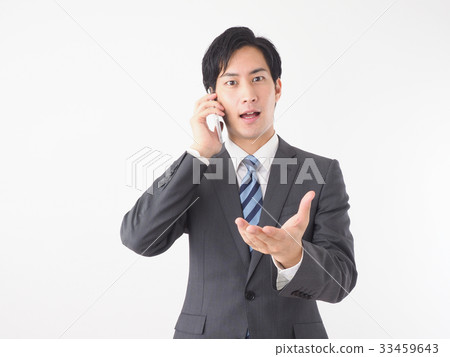 A businessman talking on a smartphone 33459643