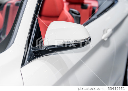 Close up of side mirror of car with turn signal. 33459651