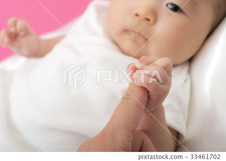 Baby holding a finger 33461702