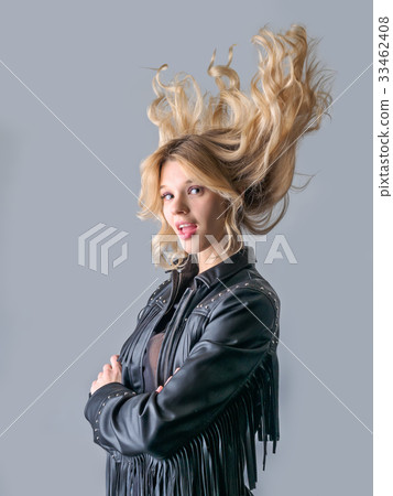 Young woman in a black leather rocker jacket. 33462408