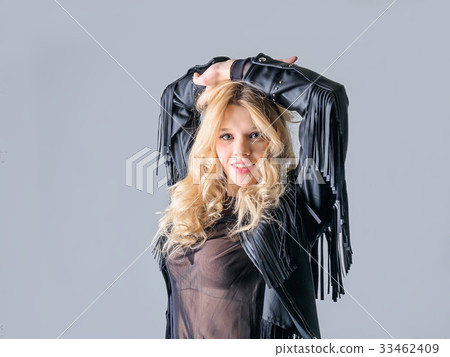 Young woman in a black leather rocker jacket. 33462409