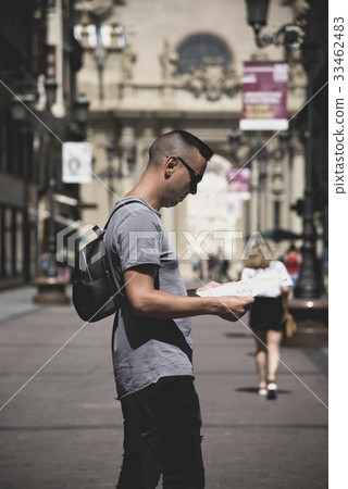 man observing a city map in Zaragoza, Spain 33462483