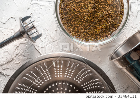 Bowl with cannabis seeds, a blender and a sieve on 33464111