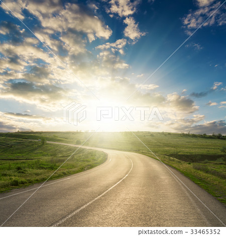 sunset in clouds over asphalt road to horizon 33465352