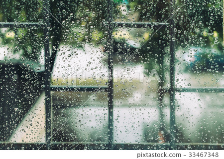 Wet window in drops during the summer rain 33467348